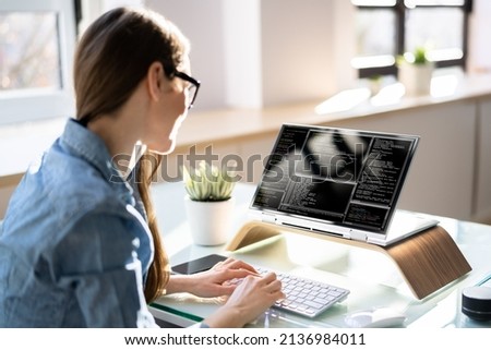 Programmer Or Coder At Office Desk Using Laptop
