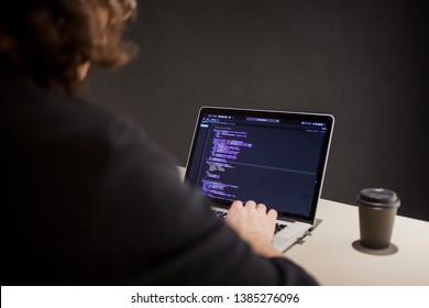 Programmer and coder working in the development environment. Programmer's workplace, laptop with project code