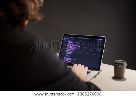 Programmer and coder working in the development environment. Programmer's workplace, laptop with project code