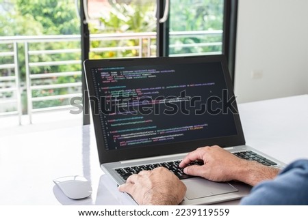 programmer coding, compiler, encode, debug, and developer application software for business corporate with laptop computer. Man programming coding web app from work at home, code show screen monitor