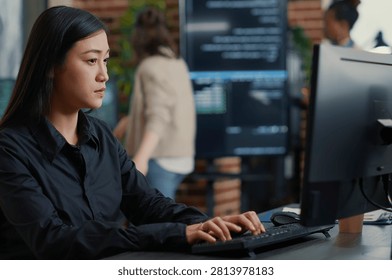 Programmer Compiling Algorithm with Team Behind in a software development office, showing programmers collaborating on source code, algorithms and data coding workflow. - Powered by Shutterstock - Get 15% off with code: PIKWIZARD15