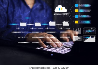 Programmer developer working on cloud data management kanban board frame work on laptop computer progression agile software data base development and binary fall down to keypad download and upload