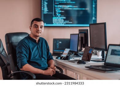 A programmer diligently testing smartphone applications while sitting in their office. - Shutterstock ID 2311984333