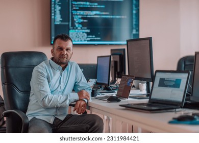 A programmer diligently testing smartphone applications while sitting in their office. - Shutterstock ID 2311984421