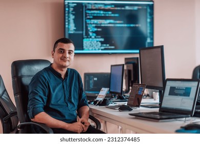 A programmer diligently testing smartphone applications while sitting in their office. - Shutterstock ID 2312374485