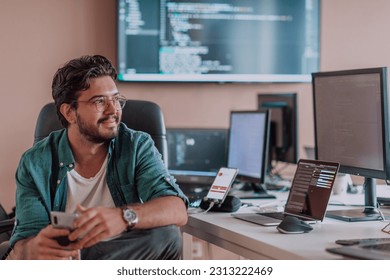 A programmer diligently testing smartphone applications while sitting in their office.
