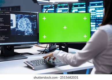 Programmer doing checkup on green screen computer in server room used for artificial intelligence workloads. IT professional inspecting neural network data center facility with chroma key PC