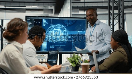 Programmer gives presentation to executives, implementing AI chatbot reducing work volume. Startup office IT expert analyzing business insights for management using artificial intelligence, camera B
