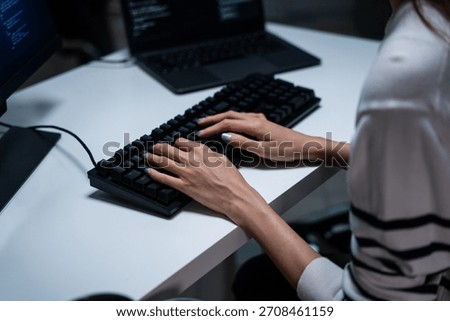 Programmer or hacker working intensely, hand typing code on keyboard. Cybersecurity, technology careers, and software development. Web developer working late night. 
