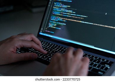 Programmer hands coding and developing software with html and javascript - Shutterstock ID 2233770725