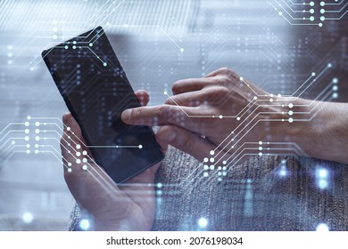 Programmer Holding In The Hands A Smart Phone And Testing An Innovative Application To Provide A Completely New Service. Close Up Shot. Hologram Tech Graphs. Concept Of Dev Team.