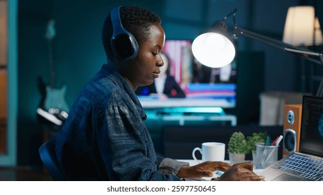 Programmer in living room office typing on keyboard, updating artificial intelligence neural networks, writing binary code scripts. Freelancing system administrator upgrading high tech AI, camera A