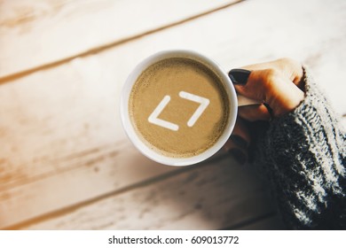 Programmer morning concept: coding symbol in a cup of coffee