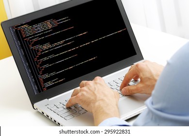 programmer profession - man writing programming code on laptop computer (code on screen is my own property) - Powered by Shutterstock - Get 15% off with code: PIKWIZARD15