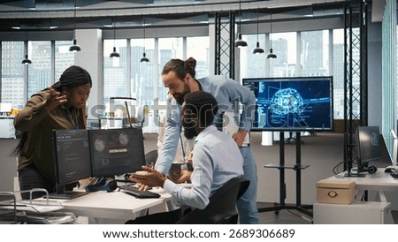 Programmer requests help from team leader to fix hacking attempt on corporate network. IT employee and manager investigating unauthorized access alerts, doing brainstorming, camera A