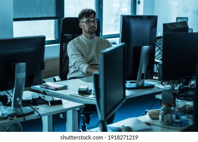 Programmer Sitting At The Desk In His Office And Trying To Solve Problem Of New Code.
