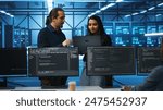Programmer and supervisor in server room looking for equipment misconfigurations, doing brainstorming. Multiracial colleagues checking data center gear bottlenecks leading to glitches