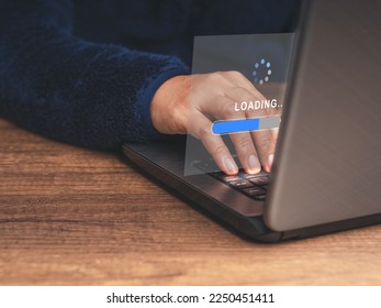 A programmer in a sweater uses a laptop for loading and processing data on a virtual screen. Software progress loading bar. Data management system. Document management system