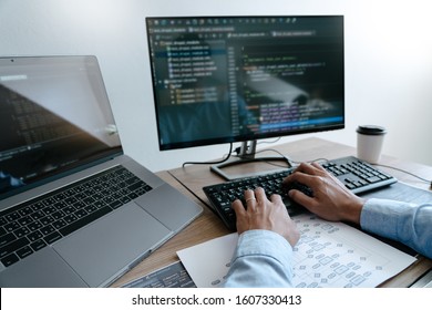 Programmer Typing Code on desktop computer, Developing programming and coding technologies concept