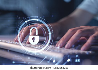 A programmer is typing a code on a keyboard to protect a cyber security from hacker attacks and save clients confidential data. Padlock Hologram icons over the typing hands.