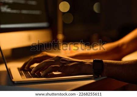 Programmer typing codes on laptop