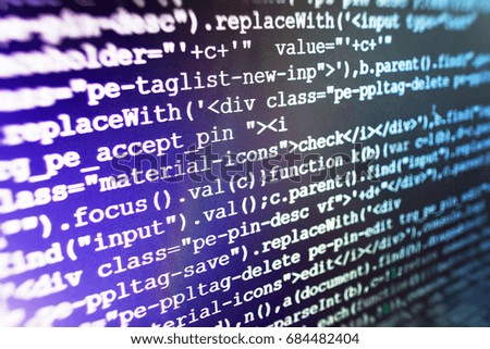 Programmer typing new lines of HTML code. Mobile app building. Young business crew working with startup. Innovative startup project. Webdesigner Workstation. IT specialist workplace. 
