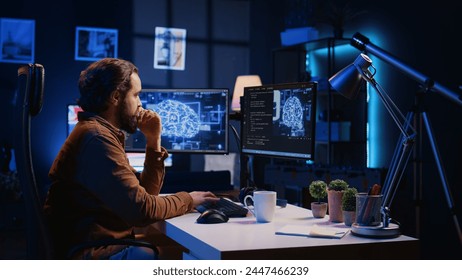 Programmer using computer to update artificial intelligence neural networks, drinking coffee and writing code scripts in home office. IT admin enjoying hot beverage while programming AI, camera B
