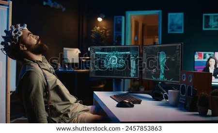 Programmer using EEG headset to upload his mind into computer, attaining immortality. Neuroscientist experimenting with transferring consciousness into cyberspace, camera B