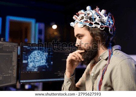 Programmer using EEG headset to upload his mind into computer, attaining immortality, with neuroscientist in apartment experimenting with transferring consciousness into cyberspace.