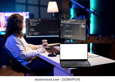 Programmer using isolated screen laptop to implement security measures, protecting company systems and data. IT worker writing, testing and debugging code for software applications on mockup notebook