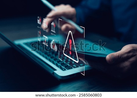 programmer using laptop with triangle caution warning sign for notification error system , hacker attacks and hacking data, cyber crime, cyber security
