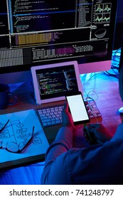 Programmer using USB cable to charge his smartphone from computer