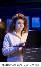 Programmer walking in apartment designing and developing software applications using laptop. IT expert standing in living room, implementing and maintaining company systems