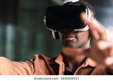 Programmer wearing virtual reality headset, exploring immersive digital workspace with hand gestures and technological engagement