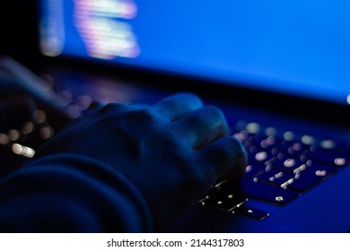Programmer who writes code at night. Close-up focused on hands