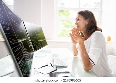 Programmer Woman Coding On Multiple Computer Screens