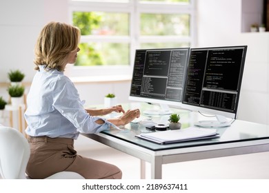 Programmer Woman Coding On Multiple Computer Screens