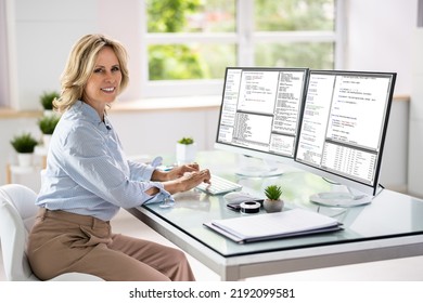 Programmer Woman Coding On Multiple Computer Screens