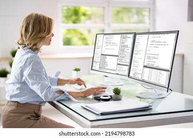 Programmer Woman Coding On Multiple Computer Screens