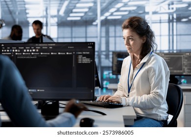 Programmer at work implementing cybersecurity measures to protect data center. Server hub facility IT specialist monitoring and analyzing metrics with device to enhance operational effectiveness