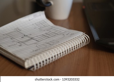 the programmer is working with a computer, a large view of the hand and a computer mouse, next to a notebook with records