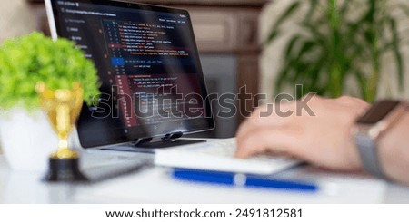 Programmer working with a computer in the office. Close-up of a man's hands typing on a keyboard. Abstract IT