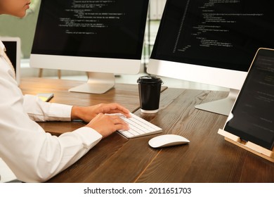 Programmer working at desk in office, closeup