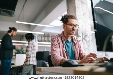 Programmer working and developing software in office