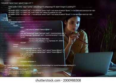 Programmer working in modern office at night