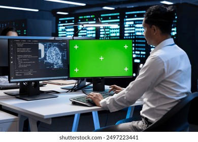 Programmer working on green screen computer in data center with artificial intelligence tech to process datasets. Employee solving tasks on mockup PC in server hub storing data used for deep learning