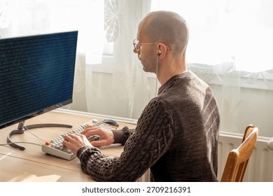 Programmer, young man in brown cable knit sweater working at computer, coding process, modern worker solving problems, specialist digital tasks, home office environment promoting productivity and calm