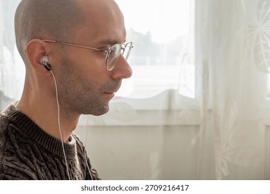 Programmer, young man in brown cable knit sweater working at computer, coding process, modern worker solving problems, specialist digital tasks, home office environment promoting productivity and calm
