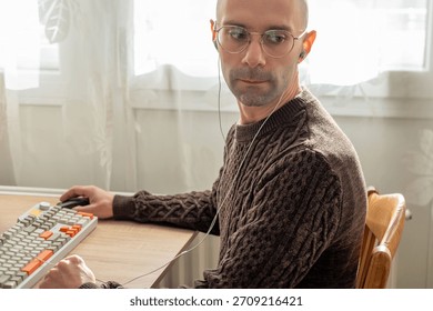 Programmer, young man in brown cable knit sweater working at computer, coding process, modern worker solving problems, specialist digital tasks, home office environment promoting productivity and calm