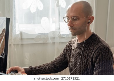 Programmer, young man in brown cable knit sweater working at computer, coding process, modern worker solving problems, specialist digital tasks, home office environment promoting productivity and calm